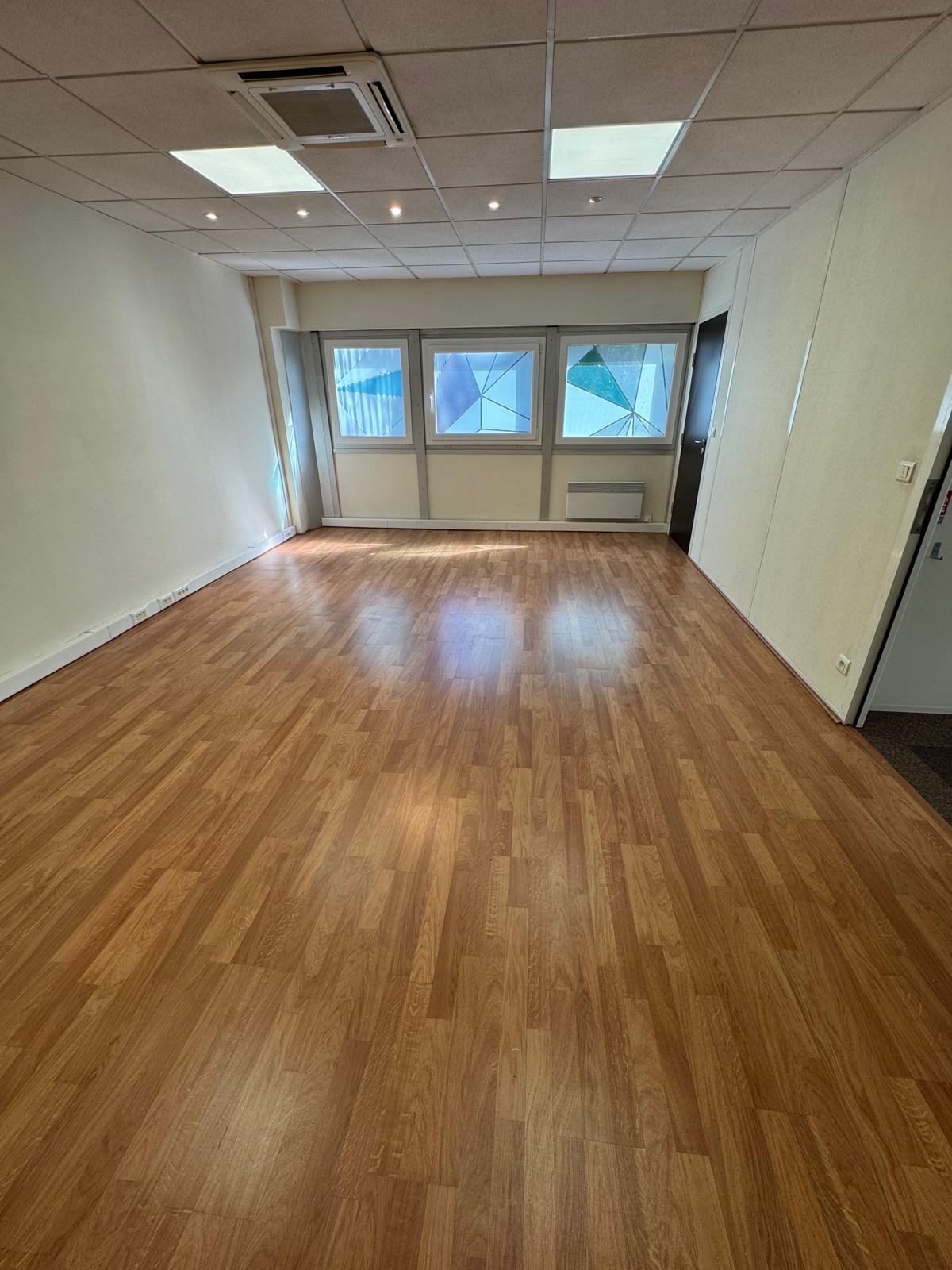 Bureau parquet climatisé avec grandes fenêtres
